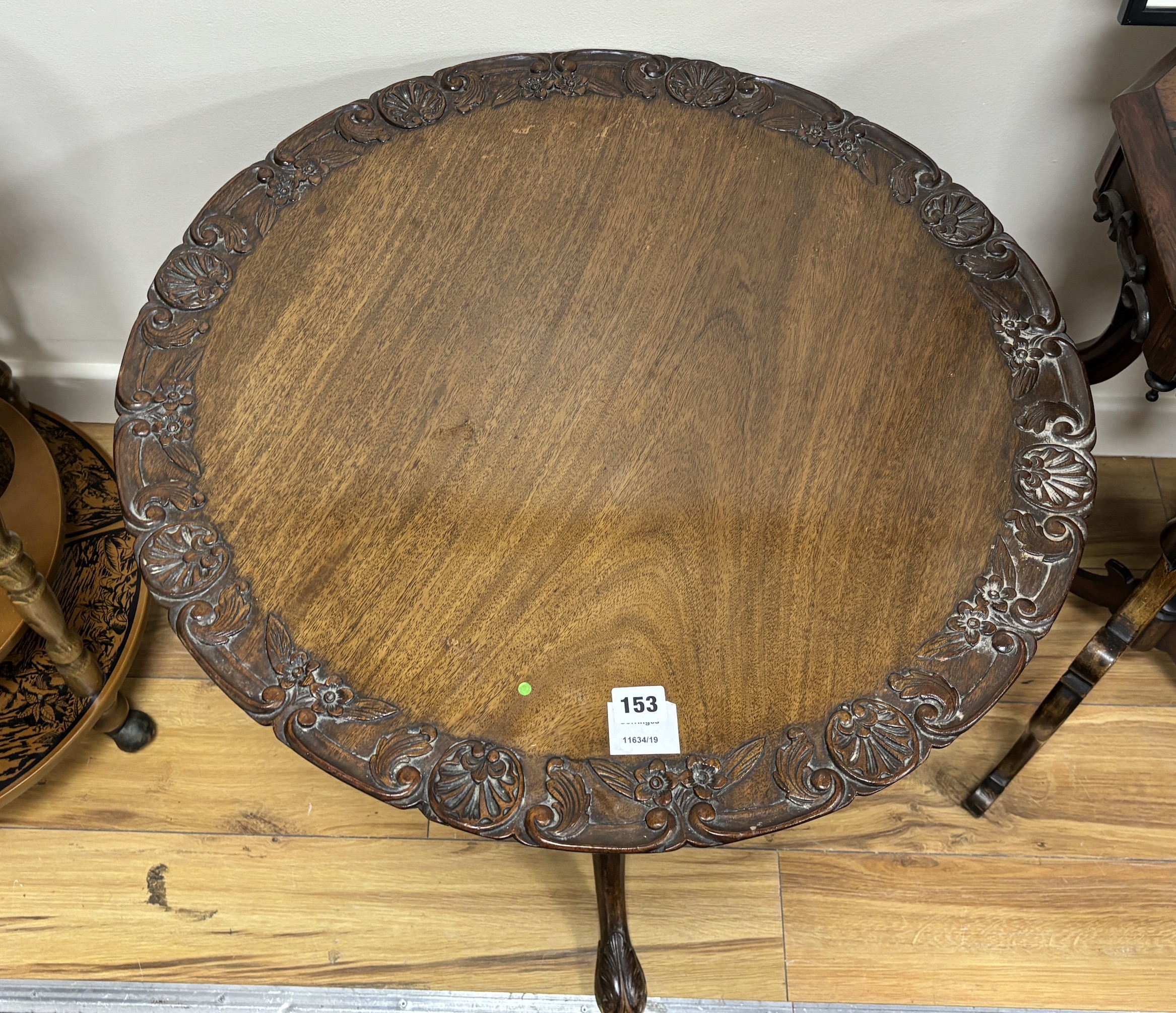 A George III mahogany tea table, on a pillar and ‘’bird cage’’ tripod base, (cut down and repairs to pillar), diameter 66cm, height 56cm